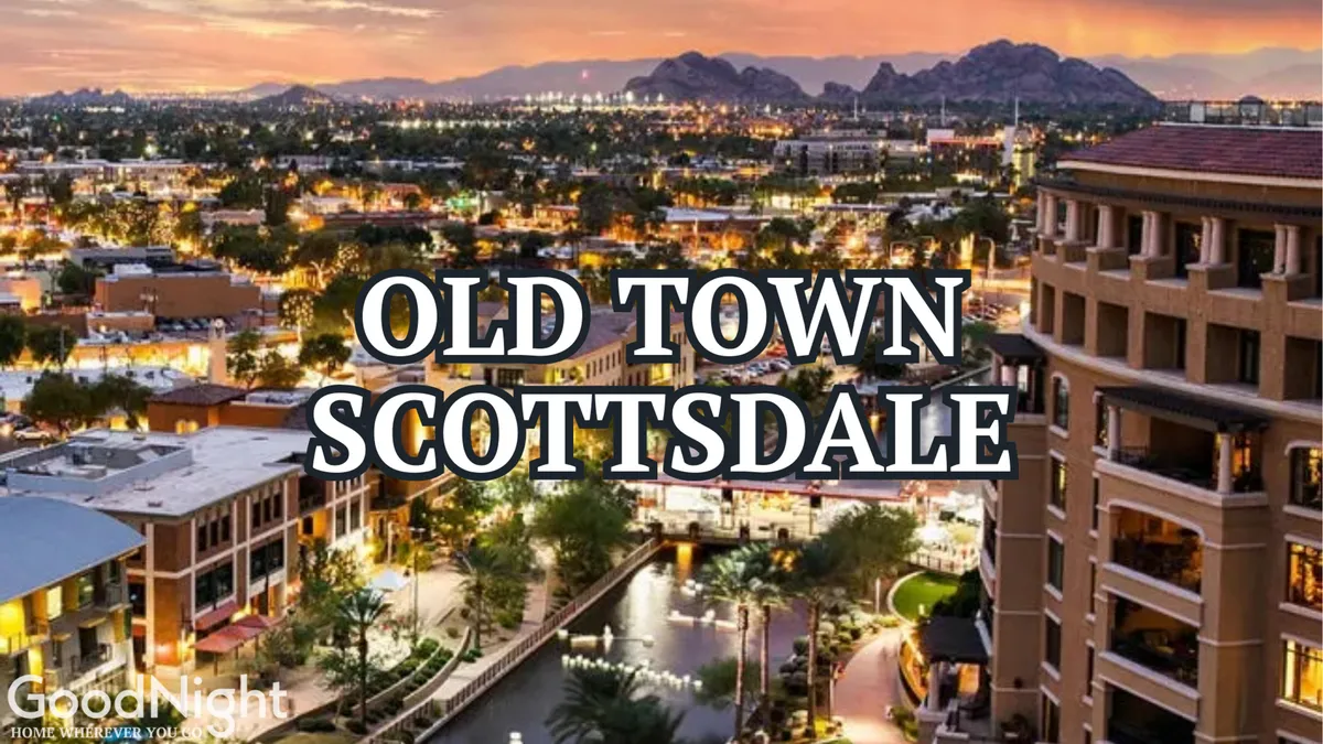 A vibrant view of Old Town Scottsdale at sunset, featuring illuminated buildings, a waterway reflecting colorful lights, and a dynamic mix of local shops and restaurants. The ambiance suggests energetic nightlife and community festivities.