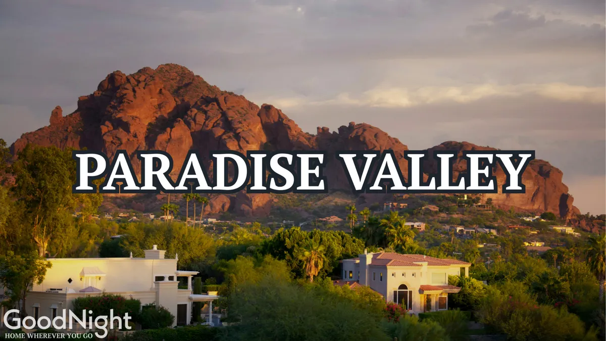 Expansive mountain views and elegant luxury homes nestled among lush greenery offer a sense of seclusion and prestige. The serene natural setting highlights the property's privileged Paradise Valley location.
